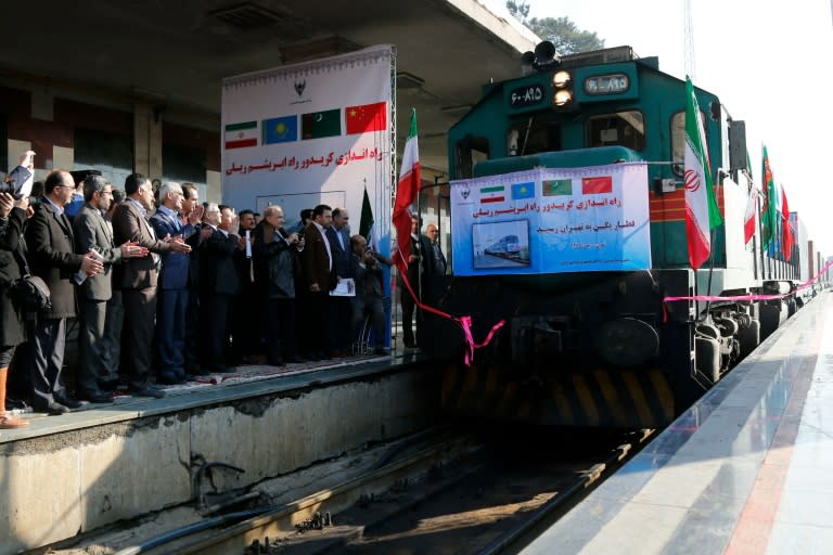 Iranian officials applaud on the platform as the first train connecting China and Iran arrives at Tehran Railway Station on February 15, 2016