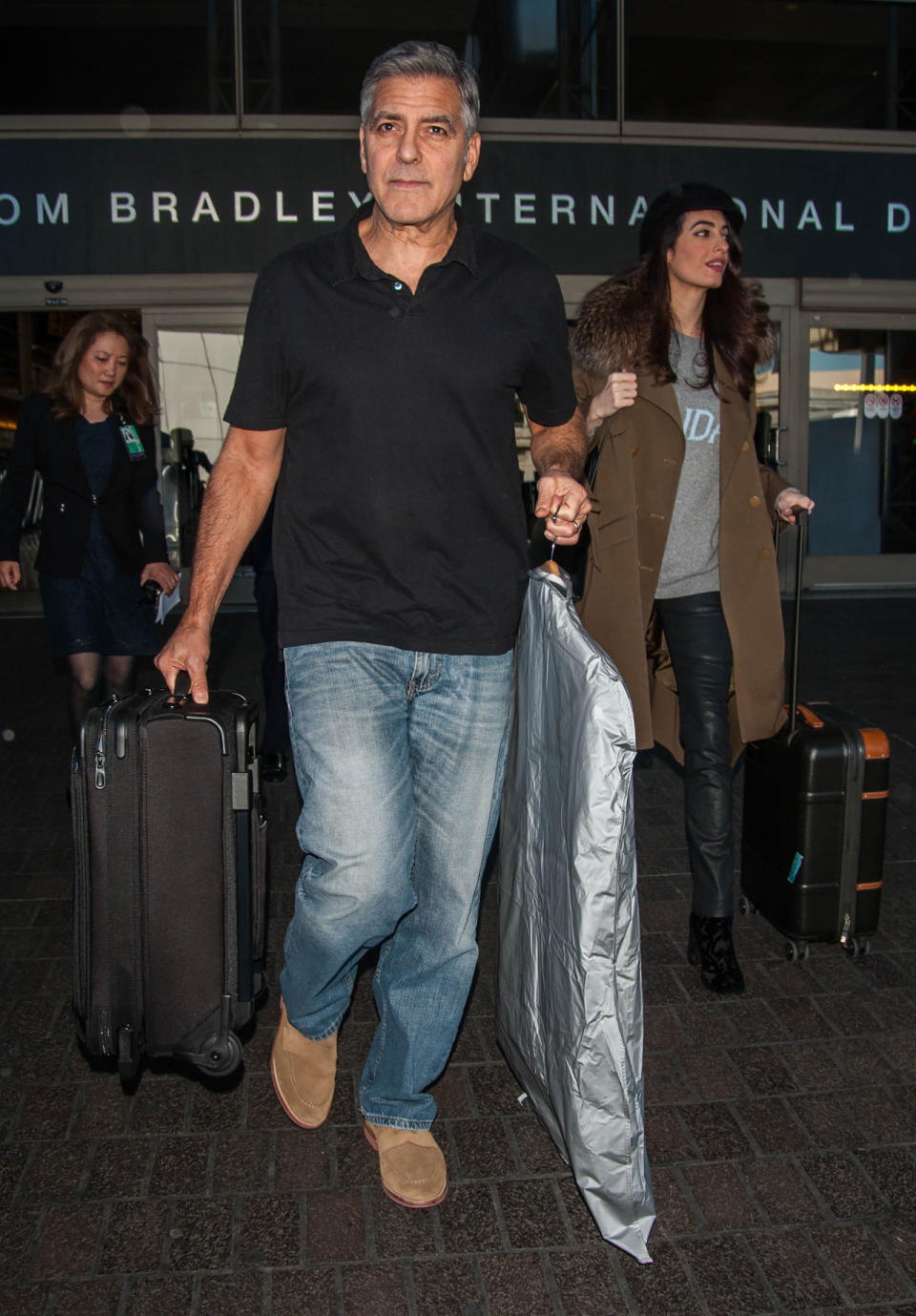 <p>Talk about sophisticated yet comfy travel style! While jetting off with husband George Clooney, Amal opted for chic leather pants, a <a rel="nofollow noopener" href="http://www.popsugar.com/fashion/Amal-Clooney-Alberta-Ferretti-Sunday-Sweater-Jan-2017-43067604#photo-43067604" target="_blank" data-ylk="slk:fun “Sunday” sweater;elm:context_link;itc:0;sec:content-canvas" class="link ">fun “Sunday” sweater</a> and a neutral coat with fur detailing. Of course, the oversized look kept persistent pregnancy rumours afloat, but whether she’s expecting or not (and really, it’s not our business!), this travel look is all kinds of #StyleGoals.<i> (Photo via Splash News)</i></p>