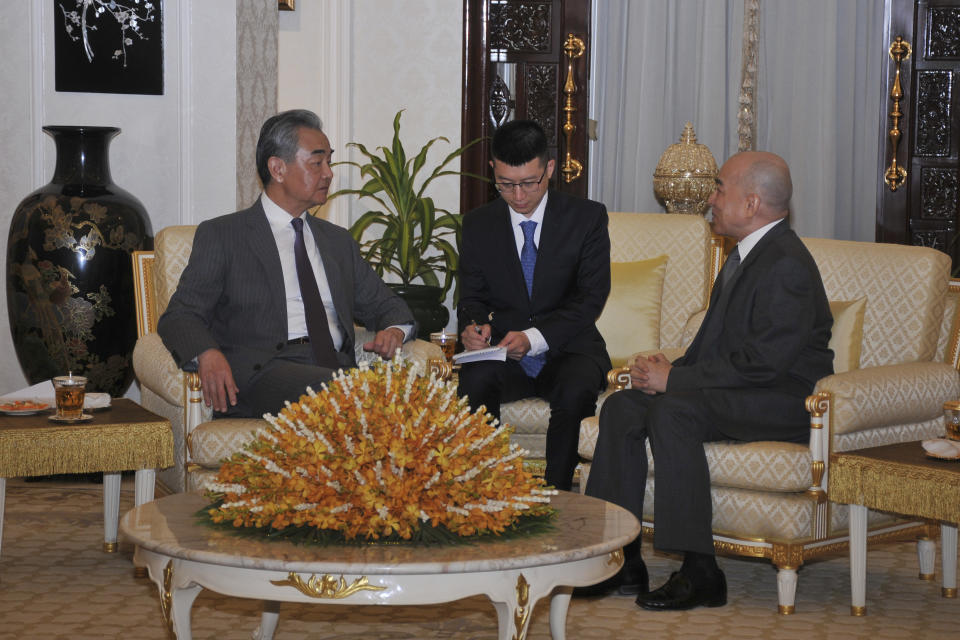 In this photo released by Agence Kampuchea Press (AKP), Chinese Foreign Minister Wang Yi, left, is welcome meeting by Cambodia's King Norodom Sihamoni, right, in Royal Palace, in Phnom Penh, Cambodia, Sunday, April 21, 2024. Wang Yi, arrived Cambodia to mark his 3 days official visit (21-23 April) Cambodia to reaffirm his country's commitment and to boost the already firmly tied to southeast Asian country, twice visited in the last eight months. (AKP via AP)