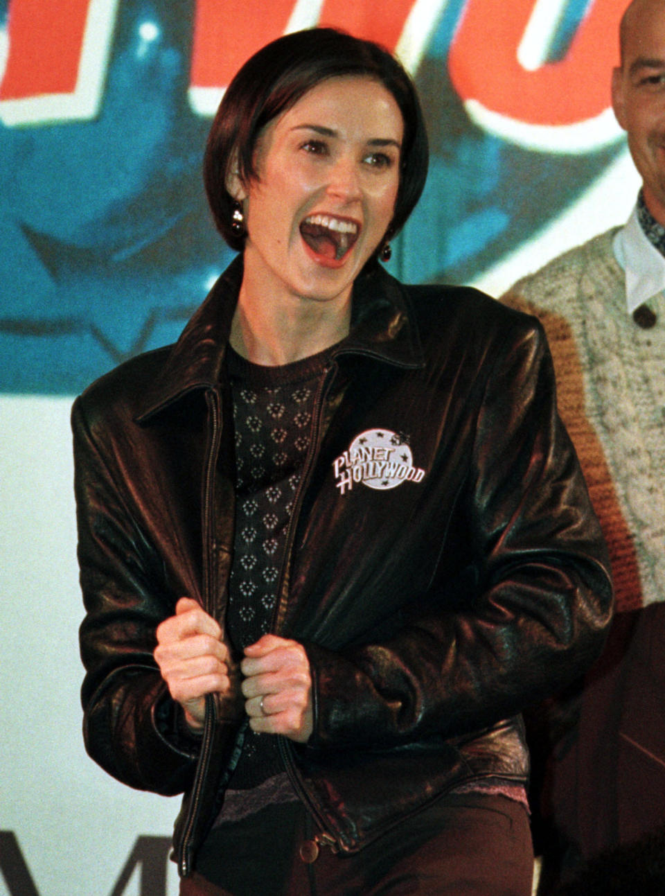 American actress Demi Moore presents a Planet Hollywood Jacket during an opening ceremony for a Planet Hollywood