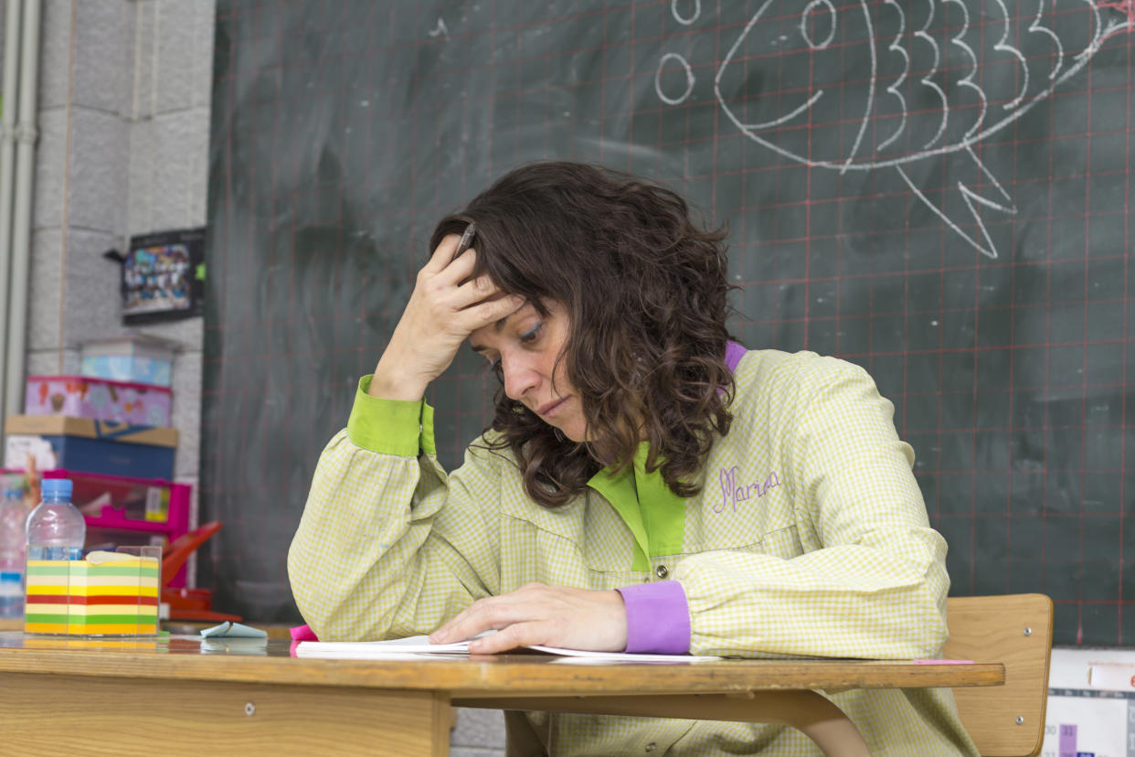 Tired and stressed teacher in classroom