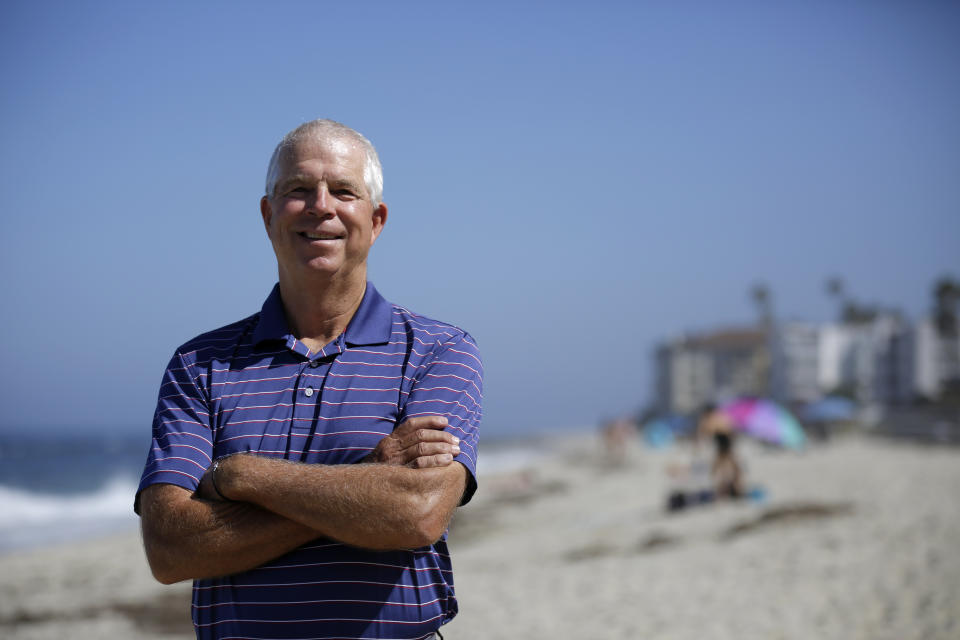 Peter Schnugg stands for a portrait along the beach Friday, July 31, 2020, in San Diego. The former waterpolo athlete missed his chance to go to the Olympics in 1980 when the U.S. decided to boycott the games to protest the Soviet Union's invasion of Afghanistan. Now he's unsure if he'll get the chance to see his niece, Maggie Steffens, try for a third consecutive gold medal with the U.S. women's water polo team. (AP Photo/Gregory Bull)