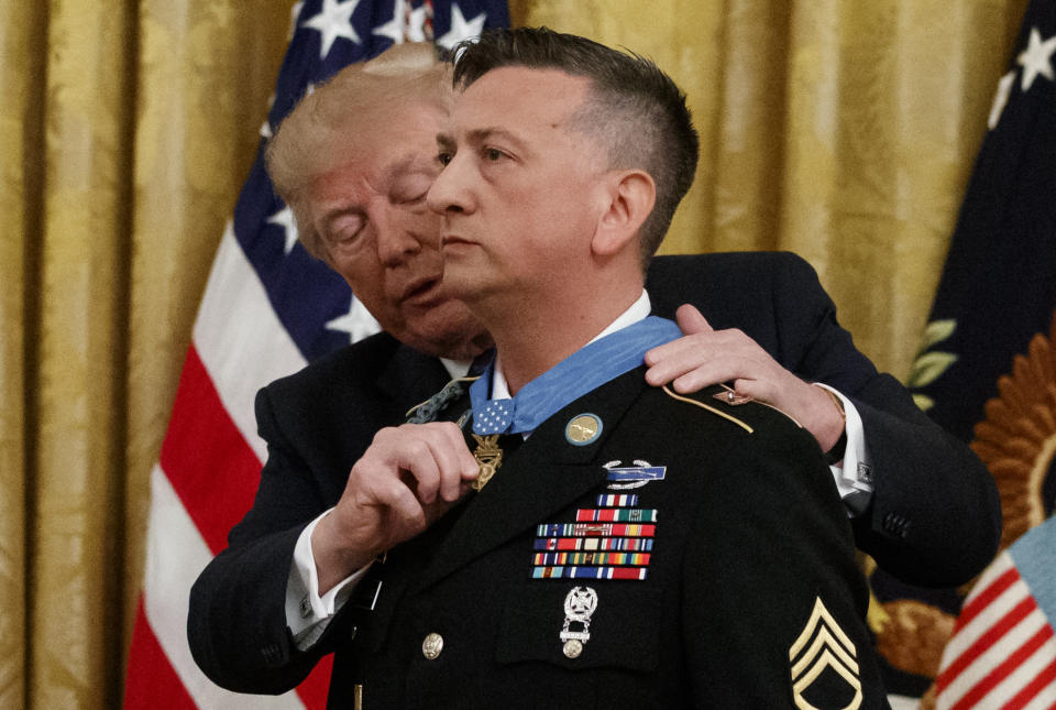 President Donald Trump awards the Medal of Honor to Army Staff Sgt. David Bellavia in the East Room of the White House in Washington, Tuesday, June 25, 2019, for conspicuous gallantry while serving in support of Operation Phantom Fury in Fallujah, Iraq. (AP Photo/Carolyn Kaster)