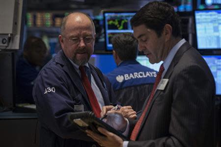Traders work on the floor of the New York Stock Exchange February 21, 2014. REUTERS/Brendan McDermid