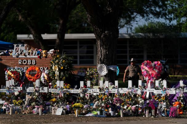 PHOTO: Flowers and candles are placed around crosses on May 28, 2022, at a memorial outside Robb Elementary School in Uvalde, Texas, to honor the victims killed in the school shooting. (Jae C. Hong/AP, FILE)