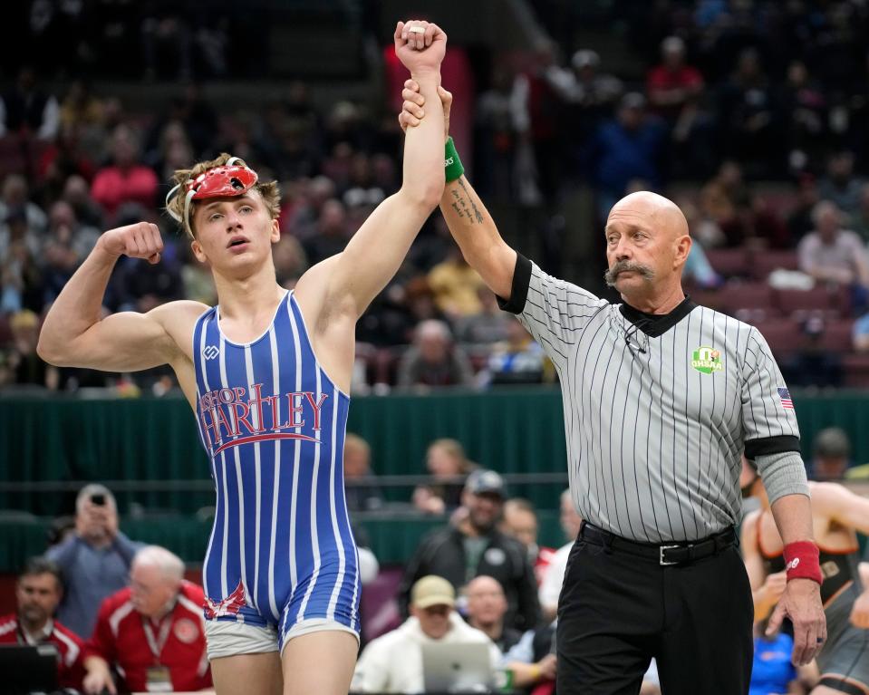 Hartley's Aiden King celebrates his Division II state title at 132 pounds.