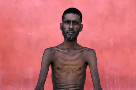 A Bangladeshi migrant who recently arrived in Indonesia by boat, sits inside a shelter after having a haircut in Kuala Langsa, in Indonesia's Aceh Province, May 19, 2015. REUTERS/Beawiharta