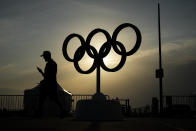 The sun sets behind the Olympic rings at the Olympic marina during the 2024 Summer Olympics, Friday, Aug. 2, 2024, in Marseille, France. (AP Photo/Daniel Cole)