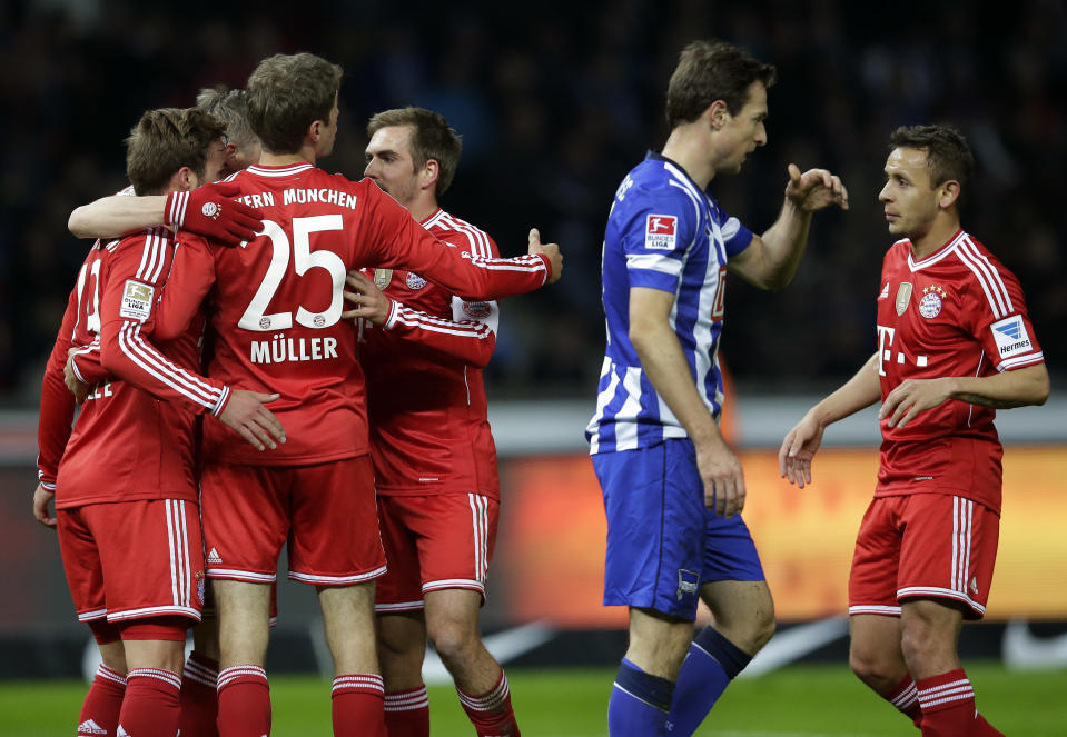 Bayern's scorer Mario Goetze, left, celebrates his side's second goal with his teammates during the German Bundesliga soccer match between Hertha BSC Berlin and Bayern Munich in Berlin, Germany, Tuesday, March 25, 2014. (AP Photo/Michael Sohn)
