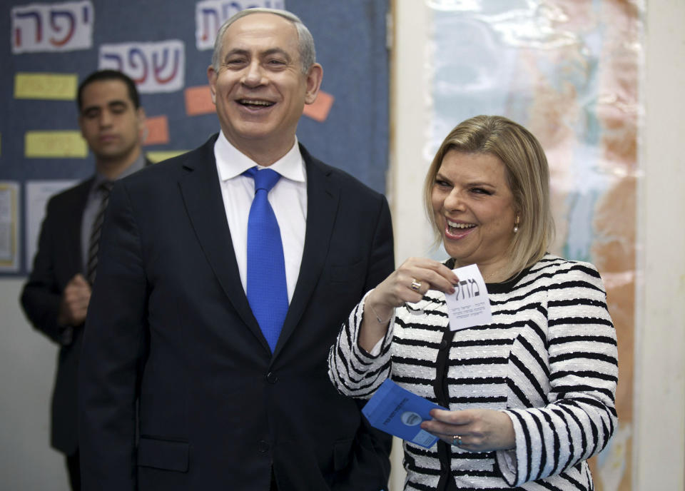 FILE - In this Tuesday, Jan. 22, 2013 file photo, Israeli Prime Minister Benjamin Netanyahu stands by his wife Sara as she casts her ballot at a polling station in Jerusalem. Netanyahu's wife Sara has come under tons of heat for her conduct as first lady, from extravagant expenses to questionable wardrobe choices to her involvement in the politics of her husband's office. Sara is Netanyahu's third wife. France’s unmarried president - and the reported love triangle involving the companion he installed into the Elysee palace and a French actress supposedly down the street - have led the country into a delicate debate over whether it needs a first lady at all. Many countries lack official status for the spouse or companion of a leader, turning up some complicated situations, even when the public is willing to turn a blind eye. (AP Photo/Uriel Sinai, File)