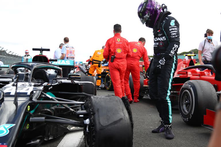 Formula One F1 - British Grand Prix - Silverstone Circuit, Silverstone, Britain - August 2, 2020 Mercedes Lewis Hamilton looks at his tyre after winning the race with a puncture on the final lap