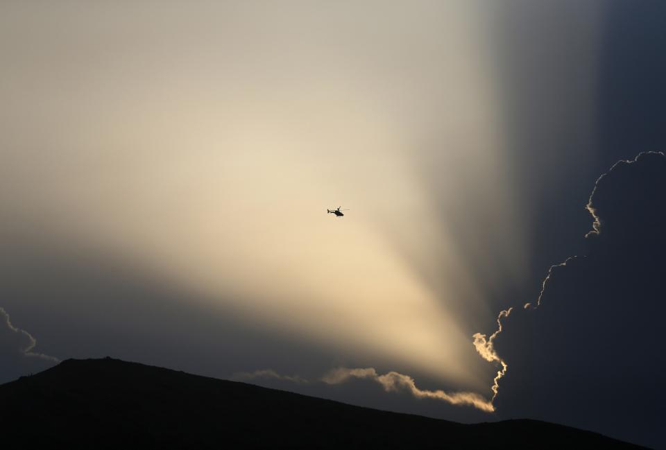 A NATO helicopter flies overhead Kabul International Airport, during an attack on the airport in Kabul July 17, 2014. Militants armed with rocket-propelled grenades attacked the airport on Thursday in one of the most audacious assaults on the facility, used by both civilians and the military, in a year. The airport is home to a major operational base for NATO-led forces that have been fighting insurgents for 12 years. (REUTERS/Omar Sobhani)