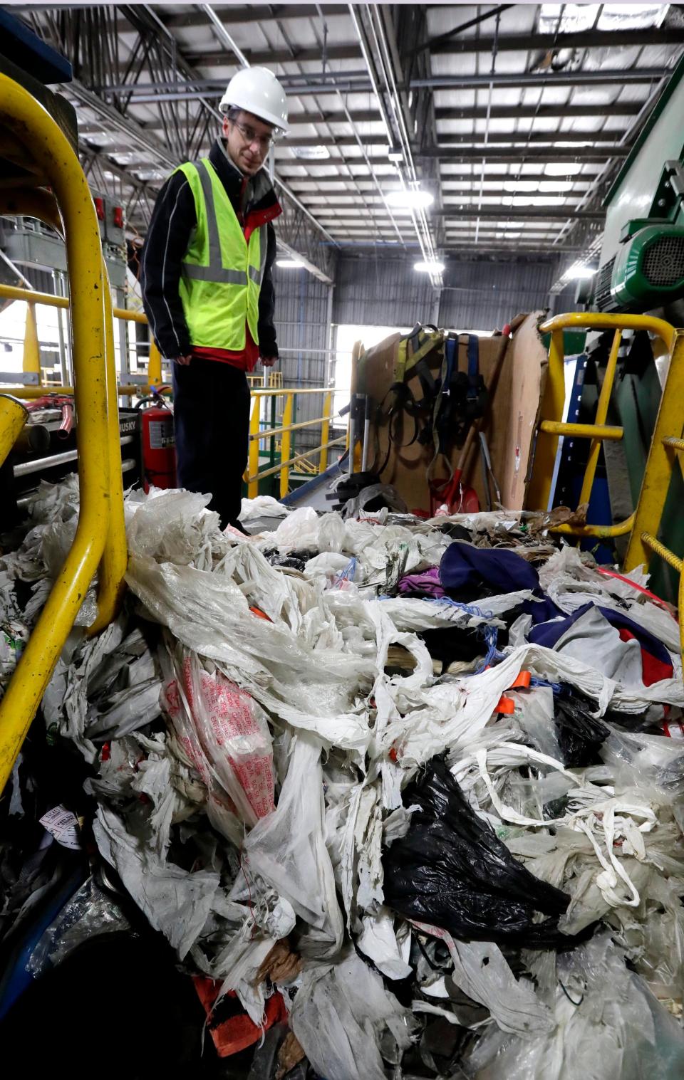 Rick Meyers, sanitation services manager at the recycling center jointly owned by the City of Milwaukee and 27 communities in Waukesha County, shows the plastic bags that were cut from the sorting machines. A conveyor lifts paper products onto spinning disks that sort and compact. Residents often put plastic bags into their recycling bins, which binds up the disks and have to be cut away manually, taking much time away from the sorting process. Recyclable items should be placed loosely in bins, not bagged.