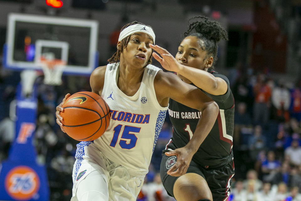 FILE - Then-Florida guard Nina Rickards (15) goes for a basket past South Carolina guard Zia Cooke (1) during the first half of an NCAA college basketball game Sunday, Jan. 30, 2022, in Gainesville, Fla. Since transfers helped Louisville reach its fourth Final Four in 2022 and the Elite Eight last season, it was the logical choice to restock his roster. It has yielded high-quality talent, albeit more seasoned. (AP Photo/Alan Youngblood, FIle)