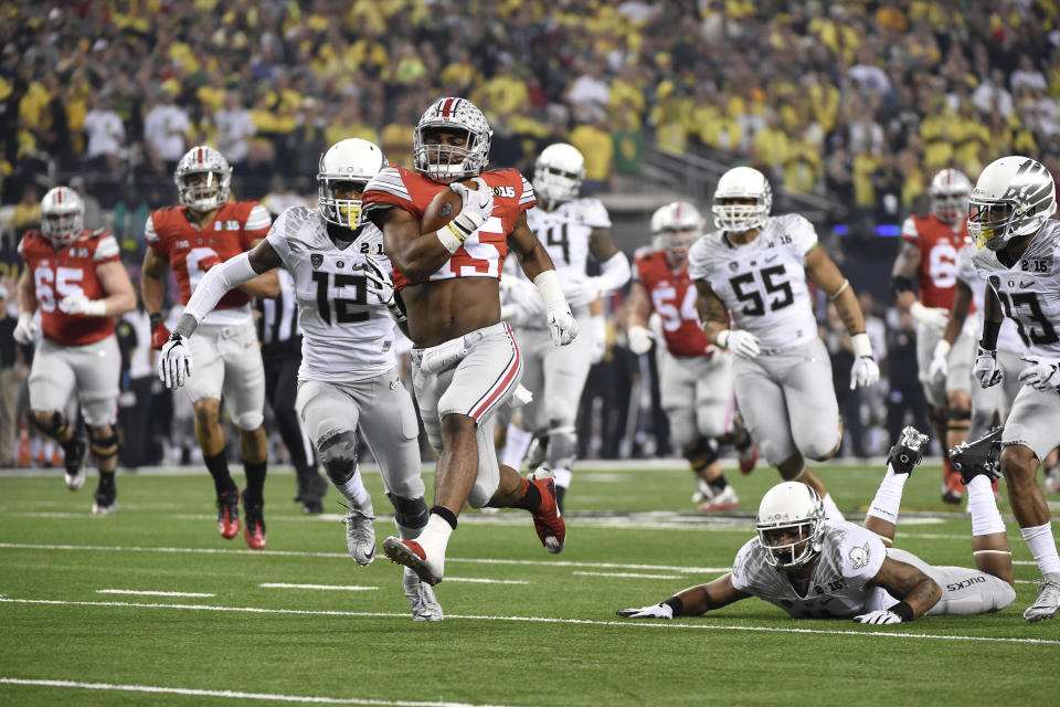 12 JAN 2015:  Ezekiel Elliott (15) of the Ohio State University rushes for a touchdown against the University of Oregon during the College Football Playoff National Championship held at AT&T Stadium in Arlington, TX.  Ohio State defeated Oregon 42-20 for the national title.  Jamie Schwaberow/NCAA Photos via Getty Images