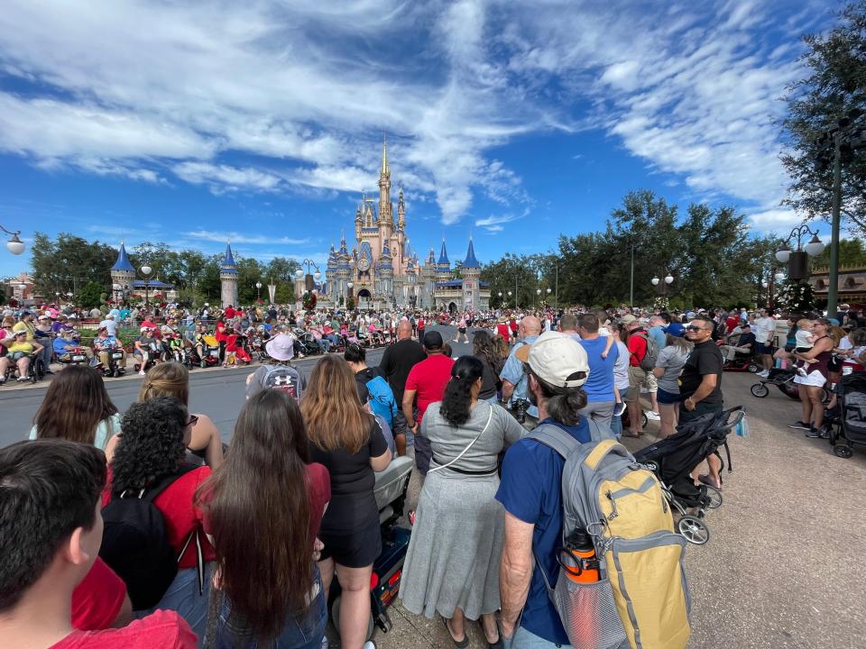 people waiting for a parade at magic kingdom during the holidays