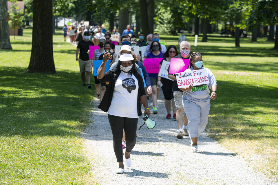 In this Friday, June 19, 2020, photo Jeannine Lee Lake, Democratic candidate for Indiana's 6th congressional district, leads a march to honor George Floyd during a Juneteenth day event in Columbus, Ind. The Democrat, who lost badly in 2018 and again faces long odds in the deeply conservative district, has spent much of the past few weeks at events like the one in Columbus, Indiana, on Juneteenth. (AP Photo/Michael Conroy)