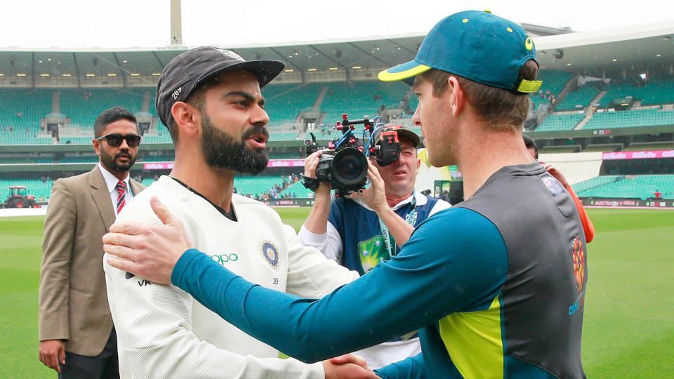 Seen here, India captain Virat Kohli embraces Australia counterpart Tim Paine.