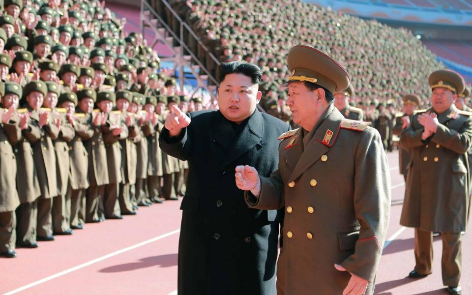 Kim Jong-un speaks with Hwang Pyong-so  - AFP