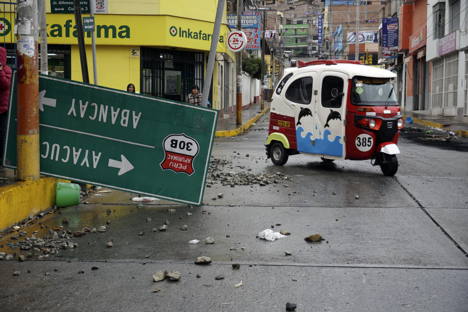 A road sign lays in the street the day after protests that called for the closure of Congress, the resignation of the new President Dina Boluarte and for general elections in Andahuaylas, Peru, Tuesday, Dec. 13, 2022. Peru's President Pedro Castillo was detained on Dec. 7 after he was ousted by lawmakers when he sought to dissolve Congress ahead of an impeachment vote. (AP Photo/Franklin Briceno)