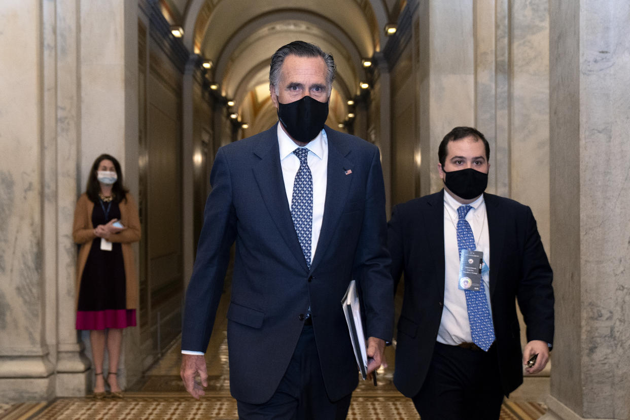 Sen. Mitt Romney, R-Utah, center, departs Capitol Hill after the Senate acquitted former President Donald Trump in his second impeachment trial in the Senate at the U.S. Capitol in Washington, Saturday, Feb. 13, 2021. (Stefani Reynolds/Pool via AP)