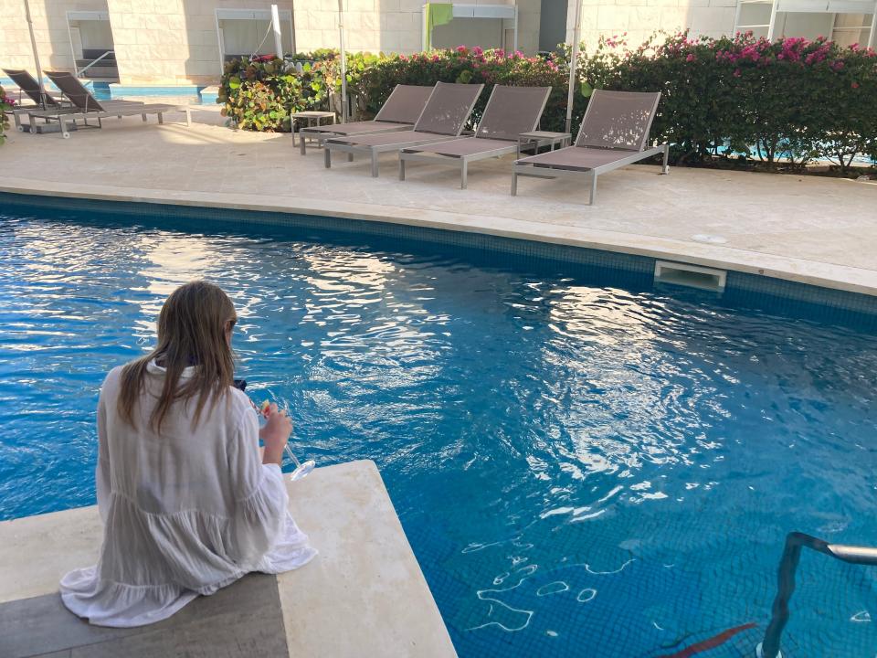 A girl sits on the terrace of a swim-up suite at The Nickelodeon Hotel.