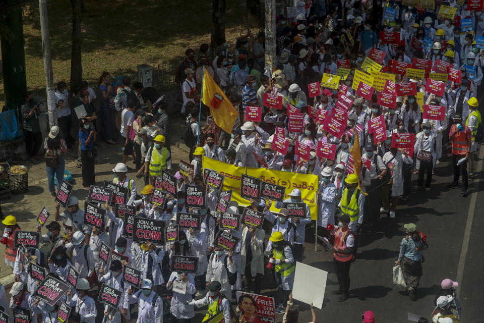 Anti-coup protesters march in Yangon, Myanmar, Thursday, Feb. 25, 2021. Social media giant Facebook announced Thursday it was banning all accounts linked to Myanmar's military as well as ads from military-controlled companies in the wake of the army's seizure of power on Feb. 1. (AP Photo)