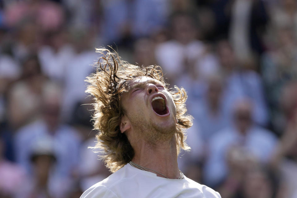 Russia's Andrey Rublev celebrates after beating Kazakhstan's Alexander Bublik in a men's singles match on day seven of the Wimbledon tennis championships in London, Sunday, July 9, 2023. (AP Photo/Kirsty Wigglesworth)