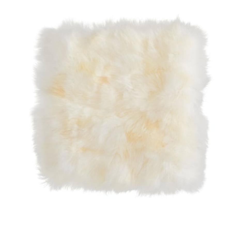 This fuzzy 20 x 20 square cushion cover has a sheepskin style. <strong><a href="https://fave.co/30xV5dK" target="_blank" rel="noopener noreferrer">Find it for $30 at IKEA</a>.</strong>