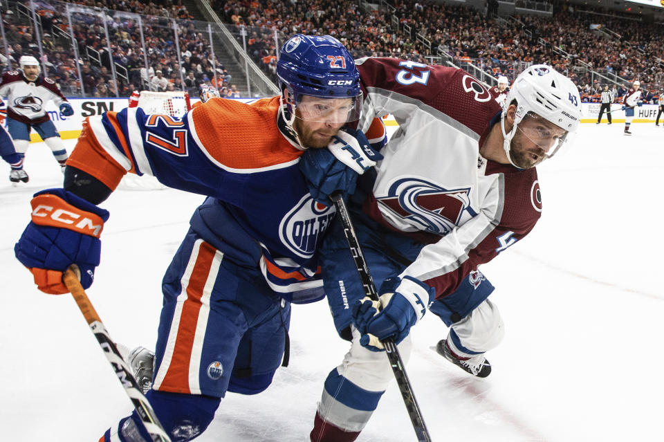 Colorado Avalanche centre Darren Helm (43) and Edmonton Oilers' Brett Kulak (27) vie for the puck during the third period of an NHL hockey game Saturday, Jan. 7, 2023, in Edmonton, Alberta. (Jason Franson/The Canadian Press via AP)