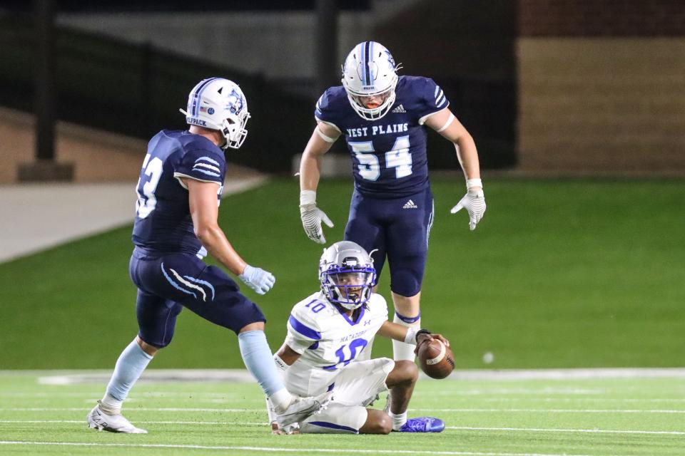 West Plains' Dawson Hall (53) and Jarrett Diggs (54) after a sack of Estacado's D.J. Johnson (10), Thursday, Sept. 22, 2022, at Happy State Bank Stadium in Canyon. West Plains won, 35-14.