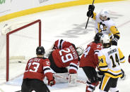 Pittsburgh Penguins center Colton Sceviour (7) celebrates after scoring a goal past New Jersey Devils goaltender Mackenzie Blackwood (29) during the second period of an NHL hockey game Friday, April 9, 2021, in Newark, N.J. (AP Photo/Bill Kostroun)