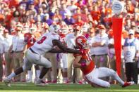 Oct 20, 2018; Clemson, SC, USA; Clemson Tigers quarterback Trevor Lawrence (16) slides while being pursued by North Carolina State Wolfpack linebacker Germaine Pratt (3) during the second quarter of the game at Clemson Memorial Stadium. Mandatory Credit: Joshua S. Kelly-USA TODAY Sports