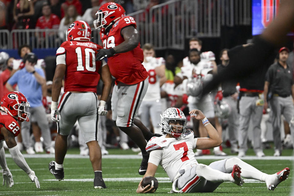 Ohio State quarterback C.J. Stroud (7) sits on the turf after being sacked by Georgia during the second half of the Peach Bowl NCAA college football semifinal playoff game, Saturday, Dec. 31, 2022, in Atlanta. (AP Photo/Danny Karnik)