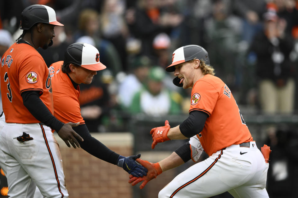 Baltimore Orioles' Gunnar Henderson, right, celebrates after his two-run home run with Adley Rutschman, center, and Jorge Mateo, left, during the seventh inning of a baseball game against the Oakland Athletics, Saturday, April 27, 2024, in Baltimore. (AP Photo/Nick Wass)