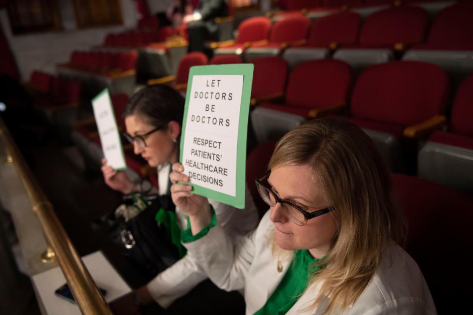 Dr. Heather Maune and Dr. Amy Gordon Bono listen from the gallery while HB 883 is discussed during a House session at the Tennessee state Capitol in Nashville, Tenn., Monday, March 20, 2023.