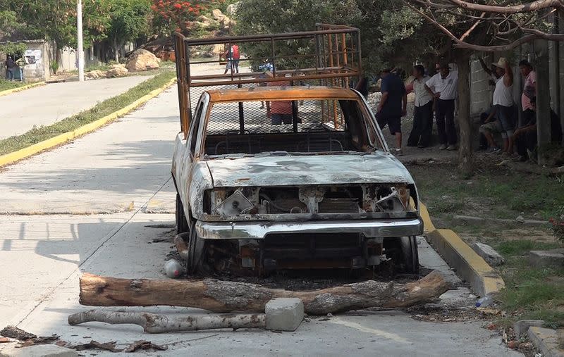 The burnt wreckage of a truck lies on a street after assailants killed 15 inhabitants of an indigenous village, that has been plagued by local disputes, in San Mateo del Mar
