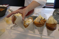 Twisted croissants with artichoke puree, a poached egg, a bit of truffle, and a bit of cheese, created by French chef Amandine Chaignot, are seen Tuesday, April 30, 2024 in Paris. Some 40,000 meals will be served each day during the Games to over 15,000 athletes housed at the Olympic village. (AP Photo/Michel Euler)