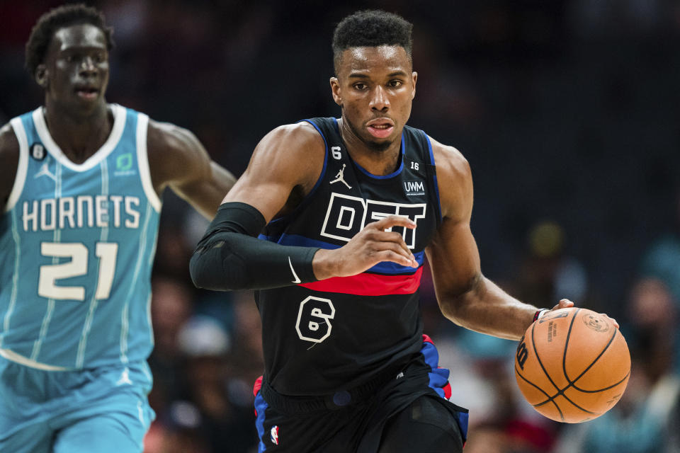 Detroit Pistons guard Hamidou Diallo (6) brings the ball upcourt while pursued by Charlotte Hornets forward JT Thor (21) during the first half of an NBA basketball game in Charlotte, N.C., Monday, Feb. 27, 2023. (AP Photo/Jacob Kupferman)