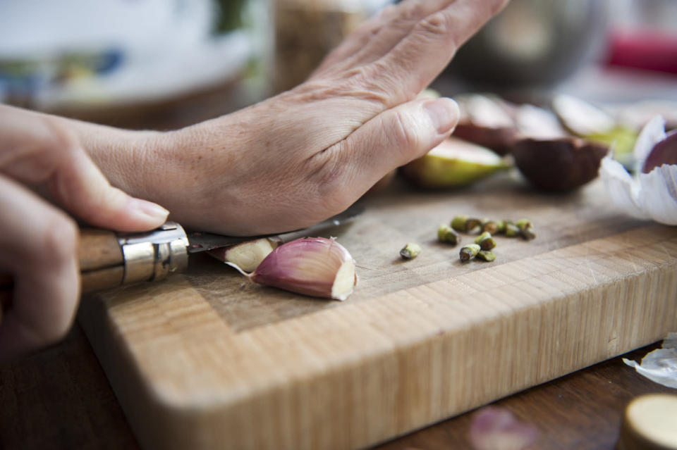Peeling garlic on a cutting board