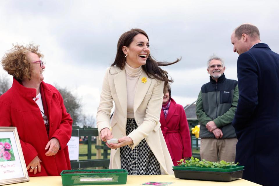 Kate laughs as she plants sweet William seeds (AP)