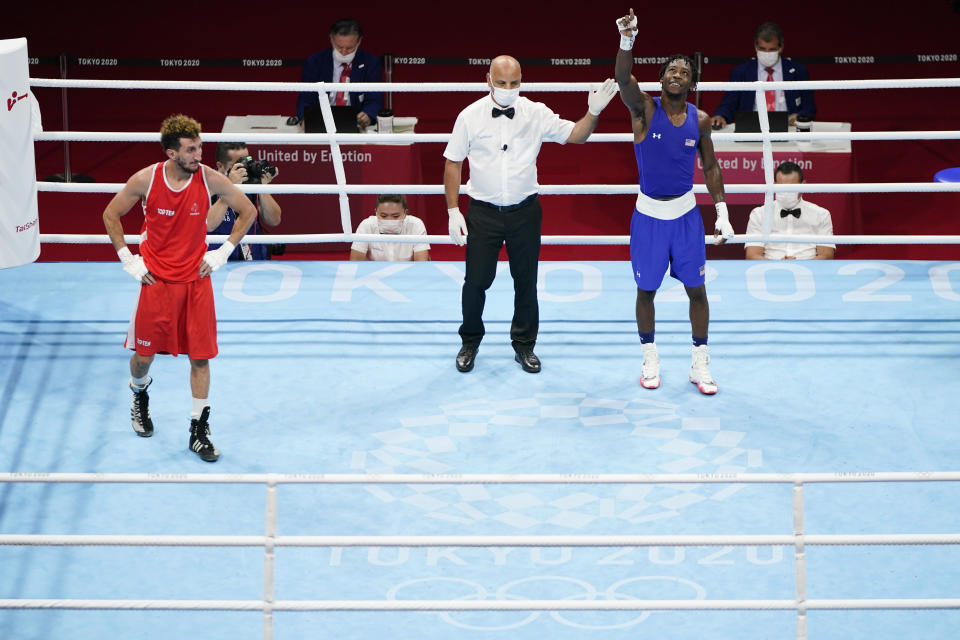France's Sofiane Oumiha, left, reacts after losing a men's lightweight 63-kg boxing match to Keyshawn Davis of the United States, at the 2020 Summer Olympics, Saturday, July 31, 2021, in Tokyo, Japan. (AP Photo/Frank Franklin II)