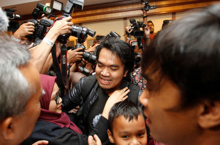 Mohd Radzuan Othman, one of the nine Malaysians who was previously stranded in Pyongyang, hugs a family member as he returns home from Pyongyang, at the Kuala Lumpur International Airport in Sepang, Malaysia. REUTERS/Lai Seng Sin