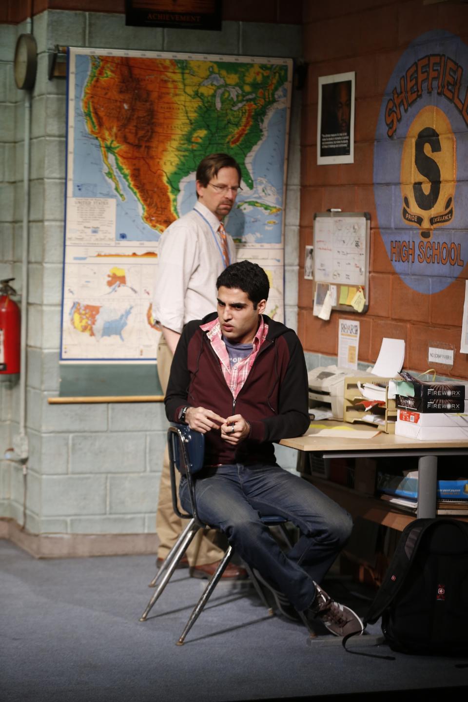 This theater image released by Sam Rudy Media Relations shows Stephen Barker Turner as Dr. Danielson, and Babak Tafti as Khadim Asmaan, foreground, from The Vineyard Theatre's production, "The North Pool." (AP Photo/Sam Rudy Media Relations, Carol Rosegg)