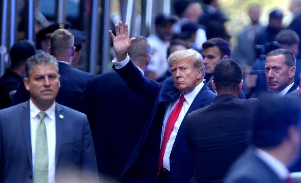 Former President Donald Trump is illuminated by blue strobe lights as he arrives at Manhattan Criminal Court in New York City Tuesday, April 4, 2023.