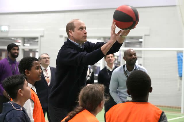 <p>Frank Augstein - WPA Pool/Getty Images</p> Prince William throws a basketball during his visit to WEST youth zone on March 14, 2024