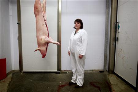 Lauraine Manson, 47, poses for a photograph at her work in an abattoir near the town of Lerwick on the Shetland Islands April 2, 2014. REUTERS/Cathal McNaughton