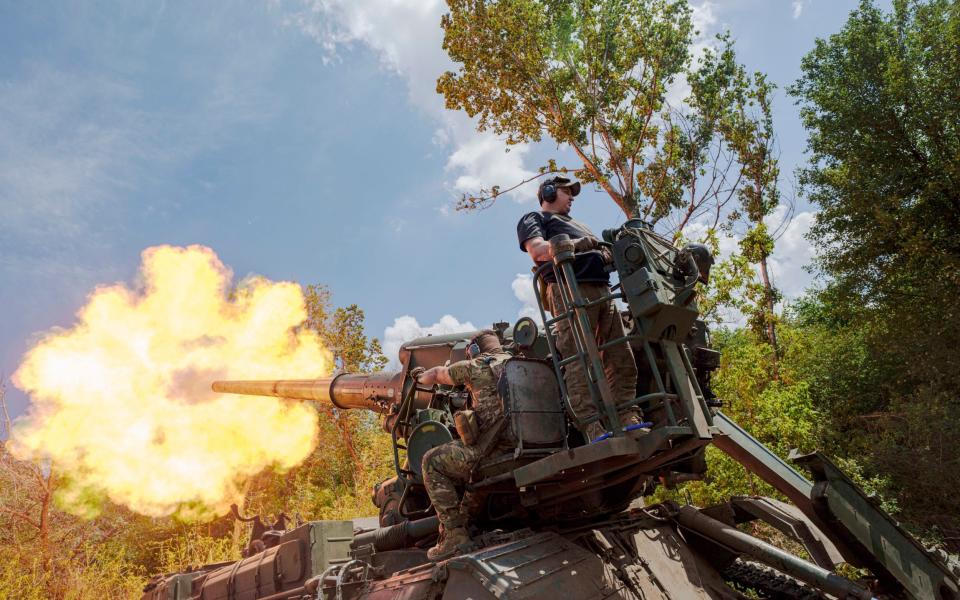 Ukrainian soldiers fire a howitzer at Russian positions near Donetsk