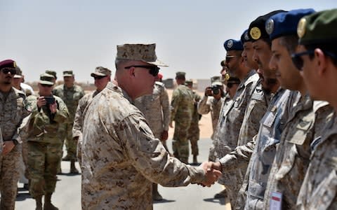 US Marine Corps General Kenneth F. McKenzie Jr. (C-L), Commander of the US Central Command (CENTCOM), shakes hands with Saudi military officers during his visit to a military base in al-Kharj in central Saudi Arabia on Thursday - Credit: AFP