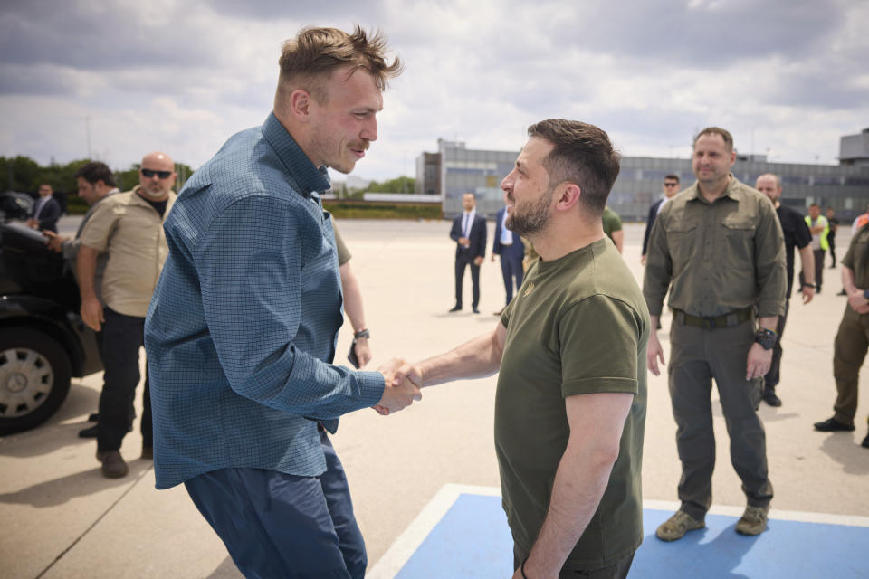 In this photo provided by the Ukrainian Presidential Press Office, Ukrainian President Volodymyr Zelenskyy, centre, shakes hands with Azov regiment commander Denys Prokopenko at Istanbul international airport in Istanbul, Turkey, Saturday, July 8, 2023. Five commanders of the defence of the Azovstal steel plant, a gruelling months-long siege early in the war, were returning from Turkey on the plane with Zelenskyy. (Ukrainian Presidential Press Office via AP)